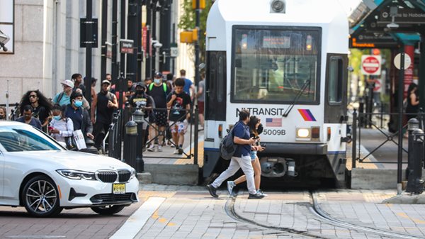 commuters getting on light rail train in Jersey City