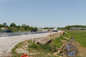 Construction on a quarter-mile segment that will be used for testing wireless power transfer to a heavy-duty electric truck as it drives across the pavement. Purdue University photo/Greta Bell
