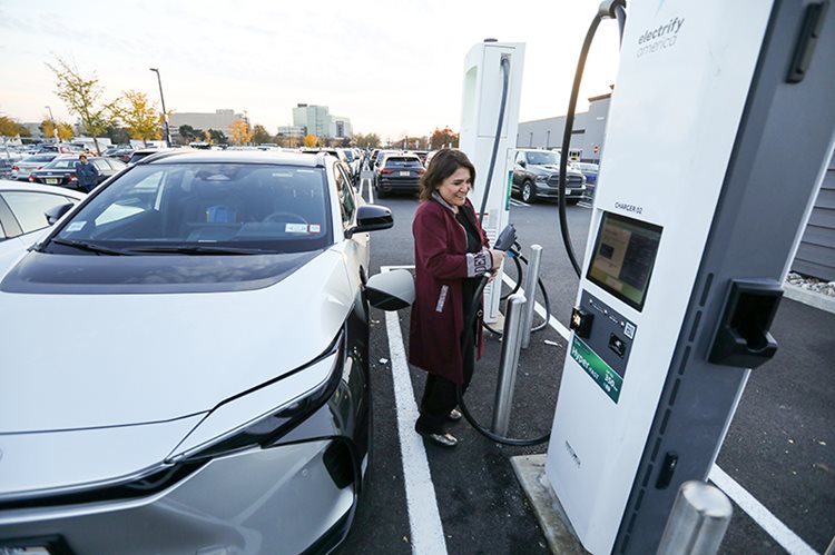 woman at ev charging station