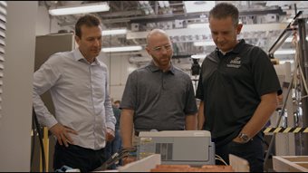 In a Purdue electrical engineering lab, Steve Pekarek, Aaron Brovont and Dionysios Aliprantis measure the electromagnetic performance of coils they are developing to transmit power to receiver coils on electric vehicles as they drive. Photo By Consensus Digital Media